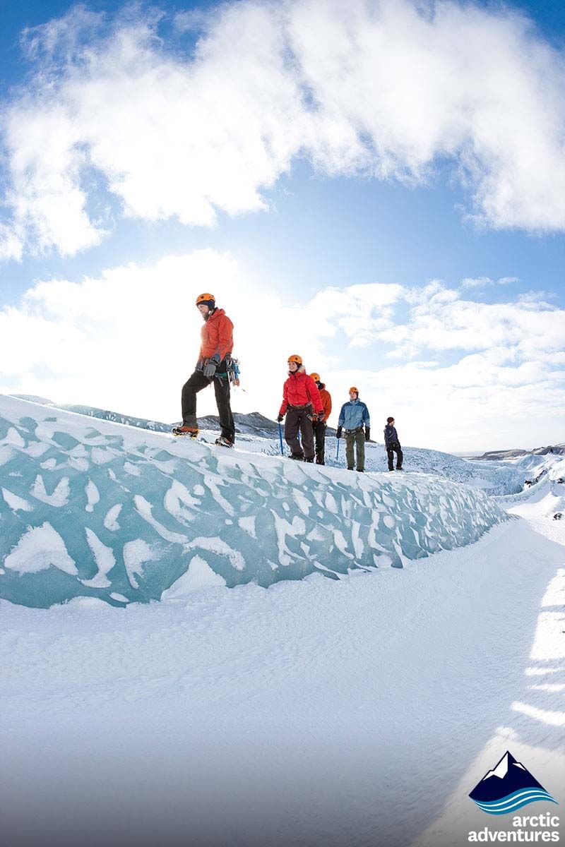 Small group hiking on glacier during South coast and northern lights tour