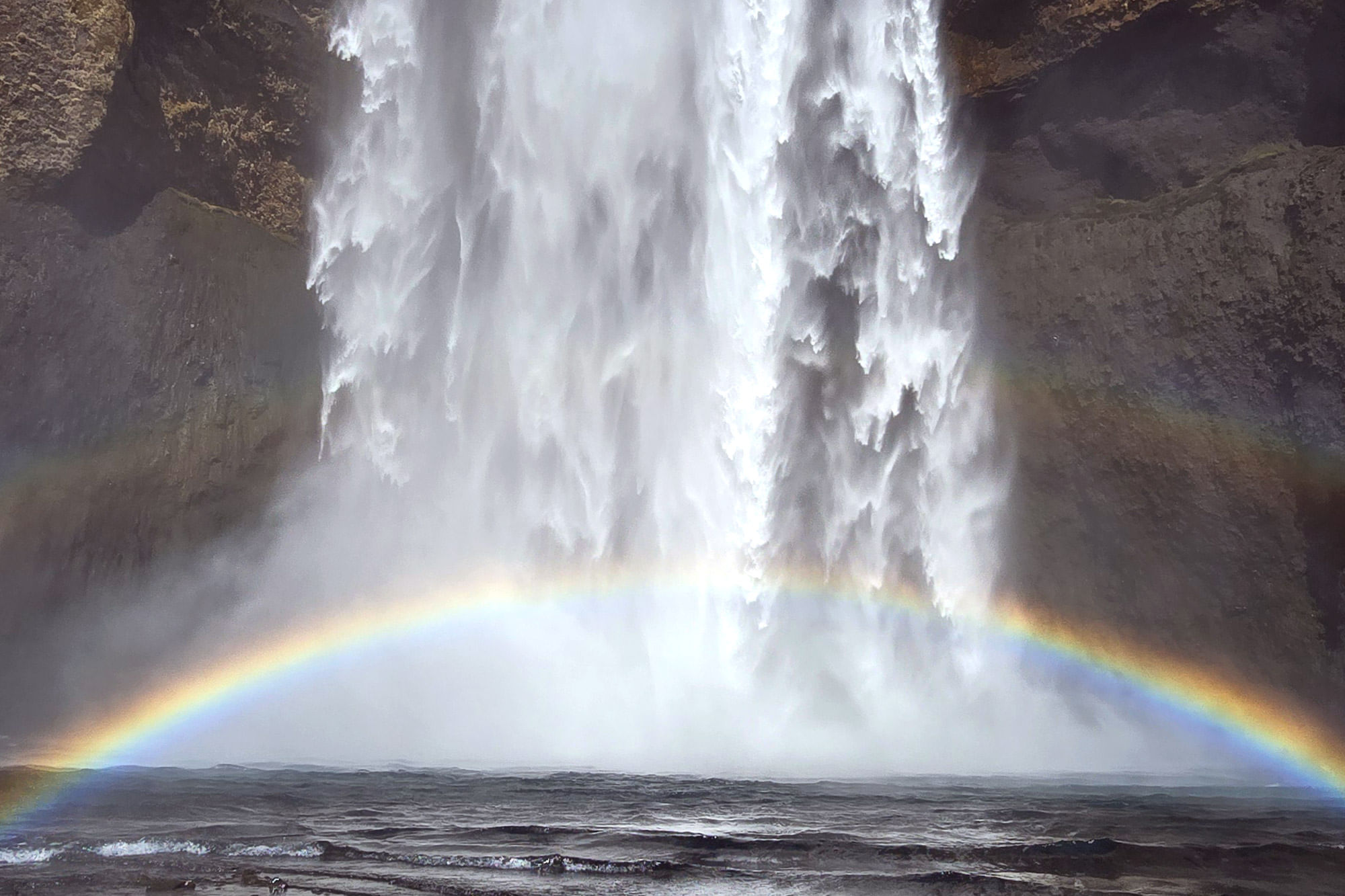 Rainbow in the spraying from the waterfall.