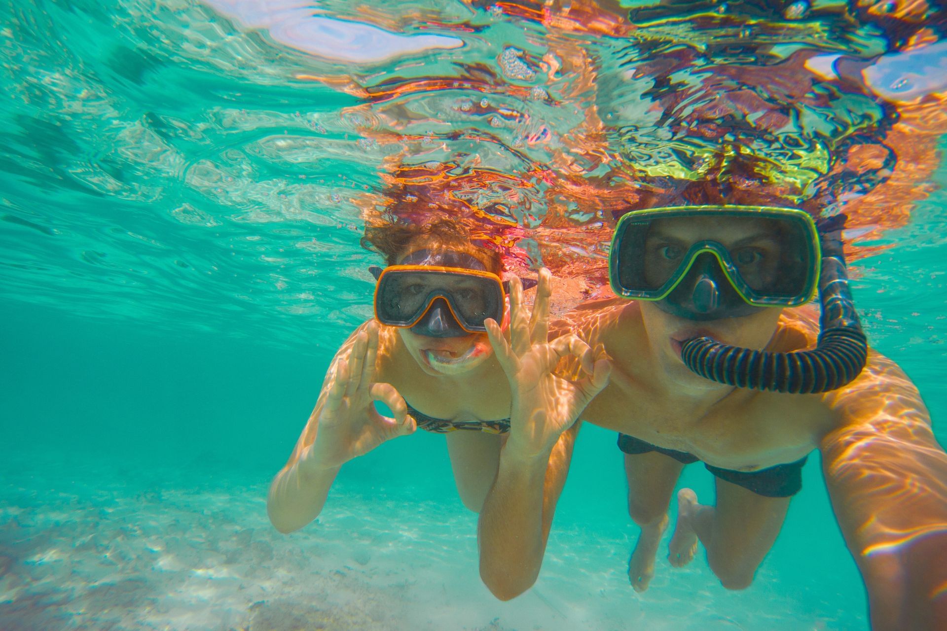 Lovely couple snorkeling at beautiful Fuik Bay